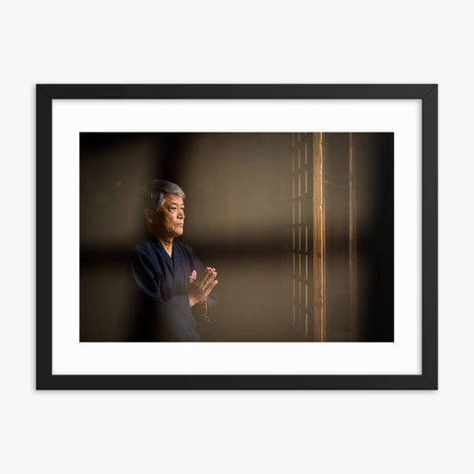 Senior Japanese man praying at a temple 18x24 in Poster With Black Frame