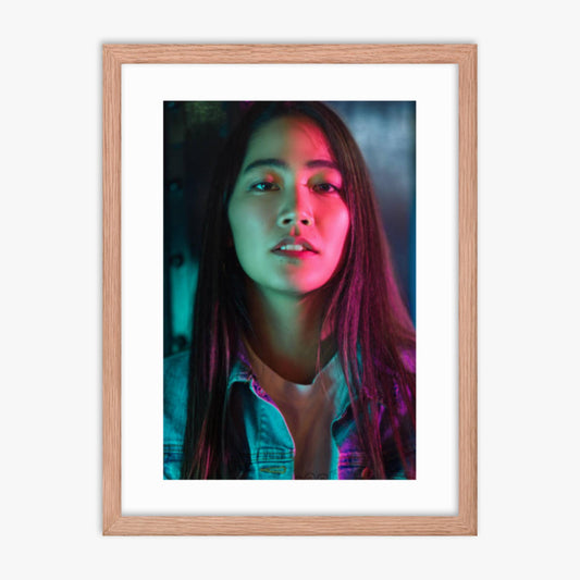 Portrait of young woman lit by colorful neon lights at night 18x24 in Poster With Oak Frame